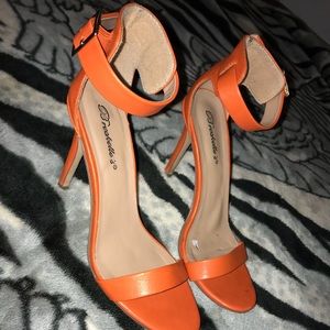 strapped and buckled: orange high heels